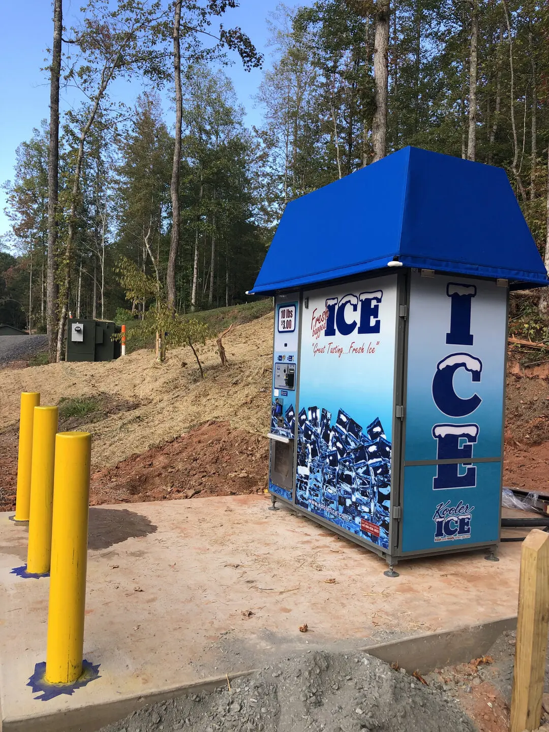 Ice machine surrounded by trees and poles