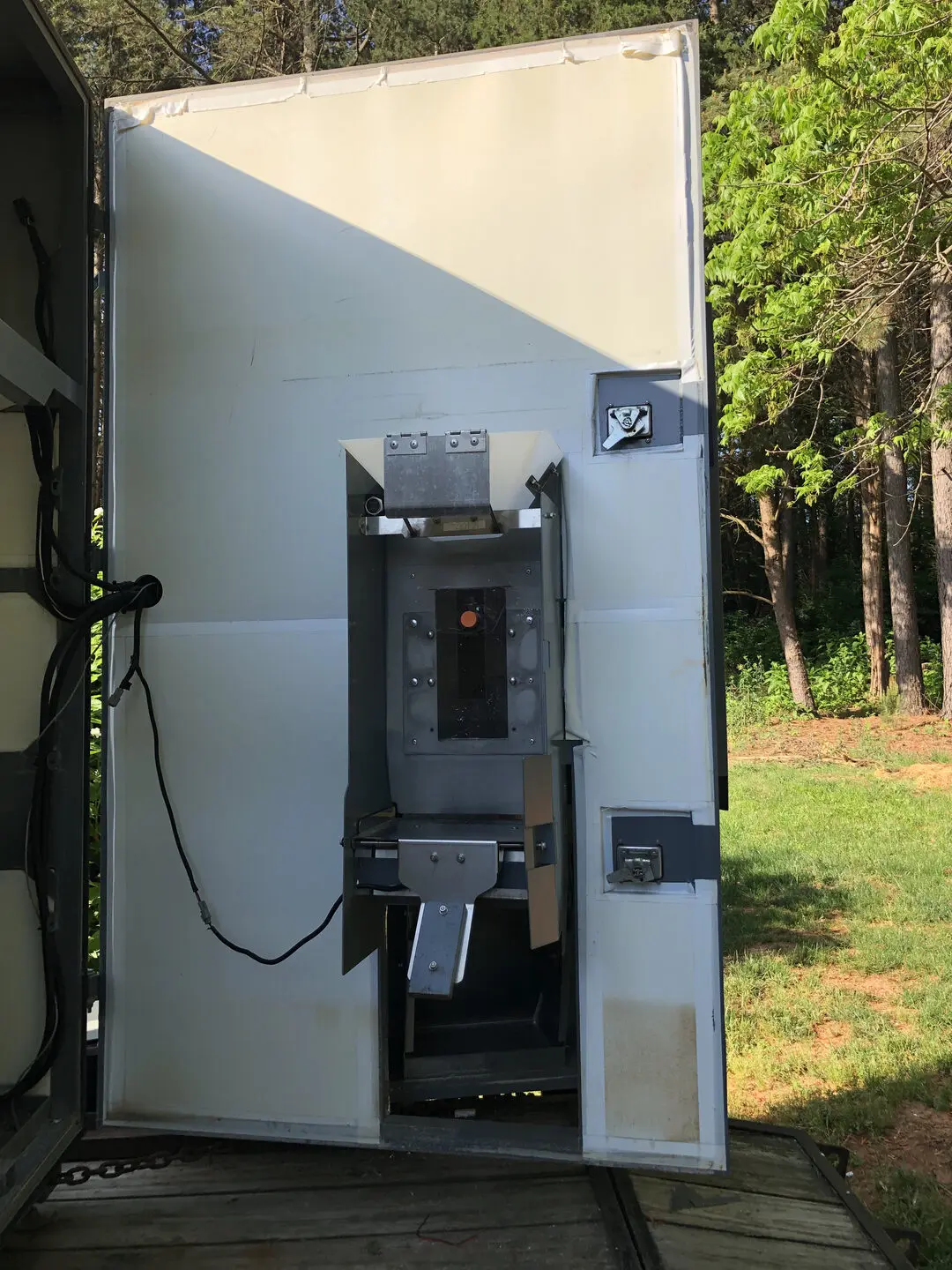 Metal machinery inside open container