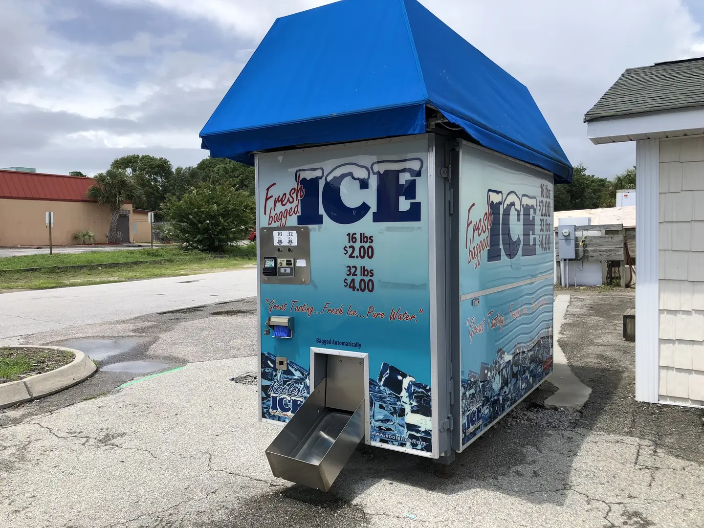 Ice vending machine under blue canopy