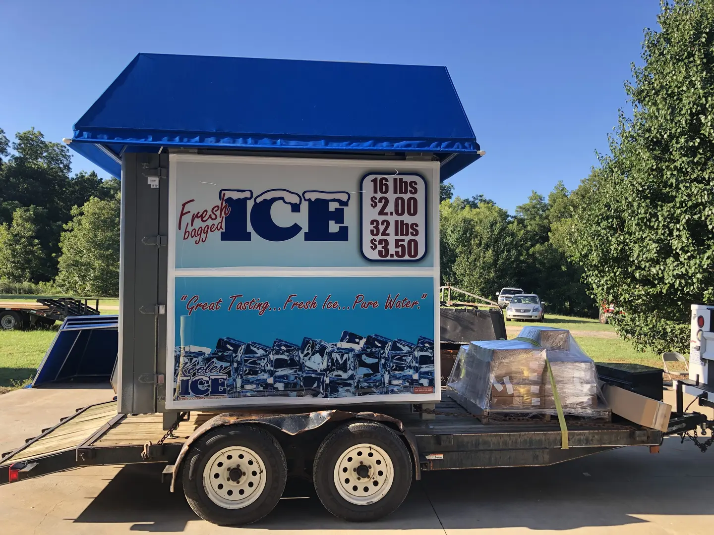 Mobile ice vendor under blue canopy