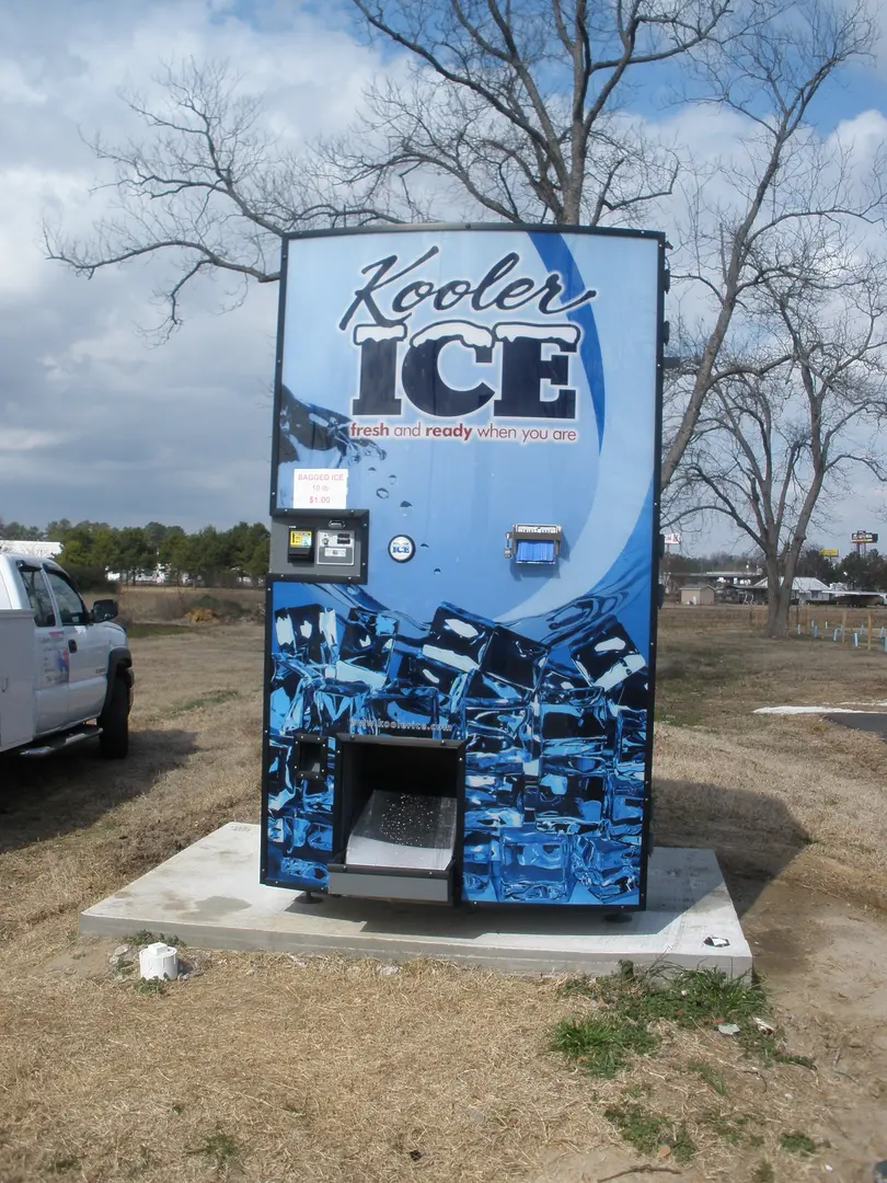 Blue vending machine with ice imagery.
